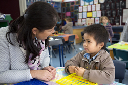 Preschool student and preschool assistant talking